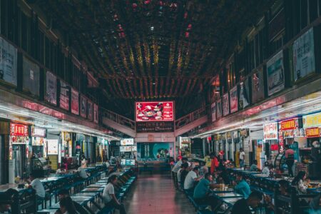 How Food Hall Operators Are Boosting Revenue Through Event Space Rentals Modern food hall interior with dining tables and open kitchen spaces
