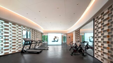 Local Gyms Generate Revenue Through Corporate Mental Health Partnerships Modern gym interior with exercise equipment and open workout space for corporate wellness programs