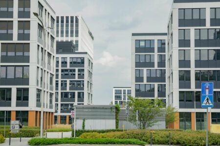 Modern corporate office building exterior with glass facades and landscaping