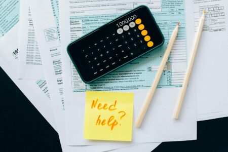 Financial calculator and documents showing retirement planning calculations and tax strategies