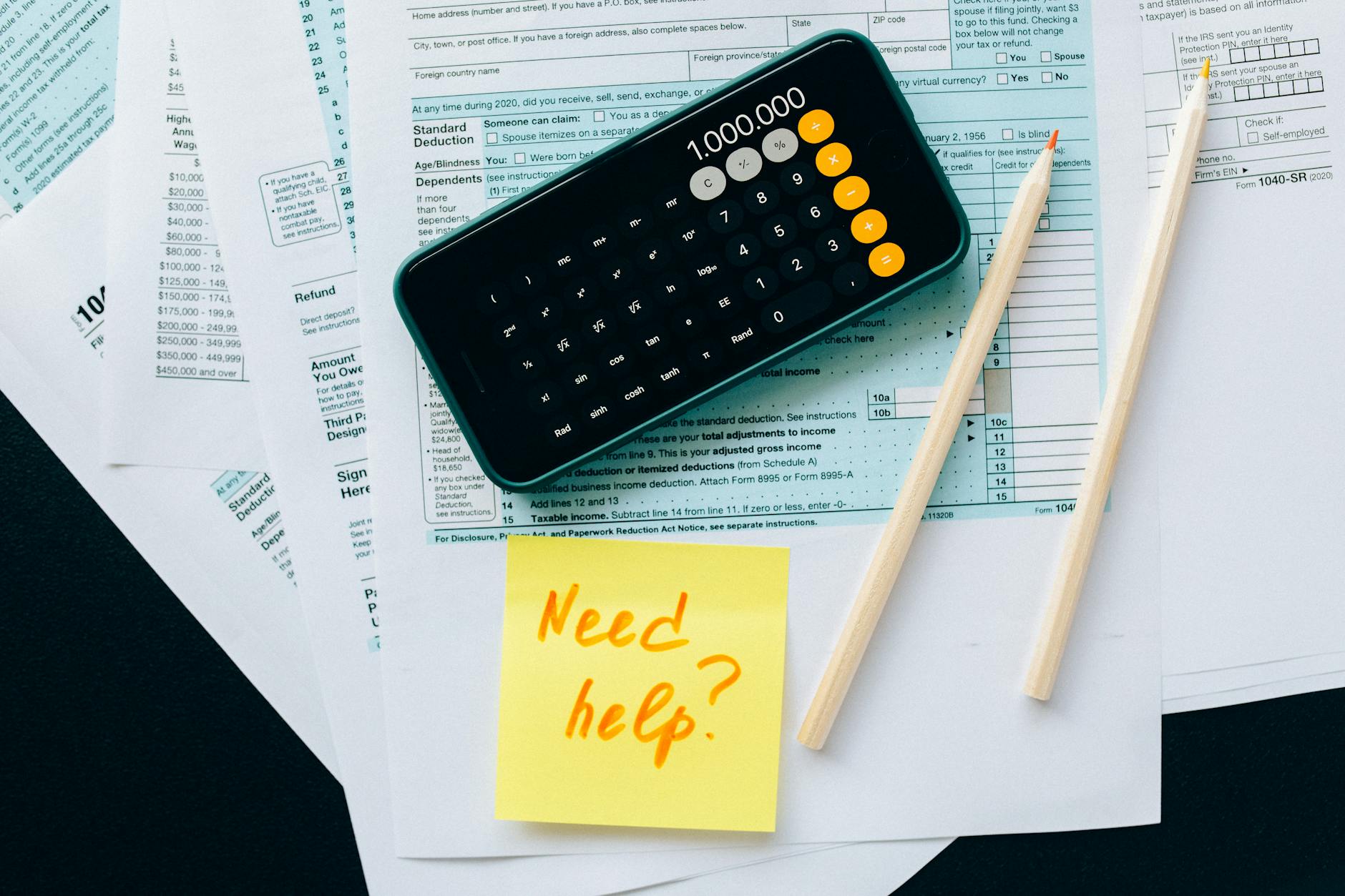 Financial calculator and documents showing retirement planning calculations and tax strategies