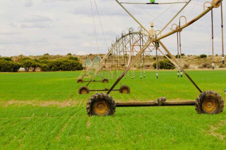 Modern irrigation system watering crops in agricultural field