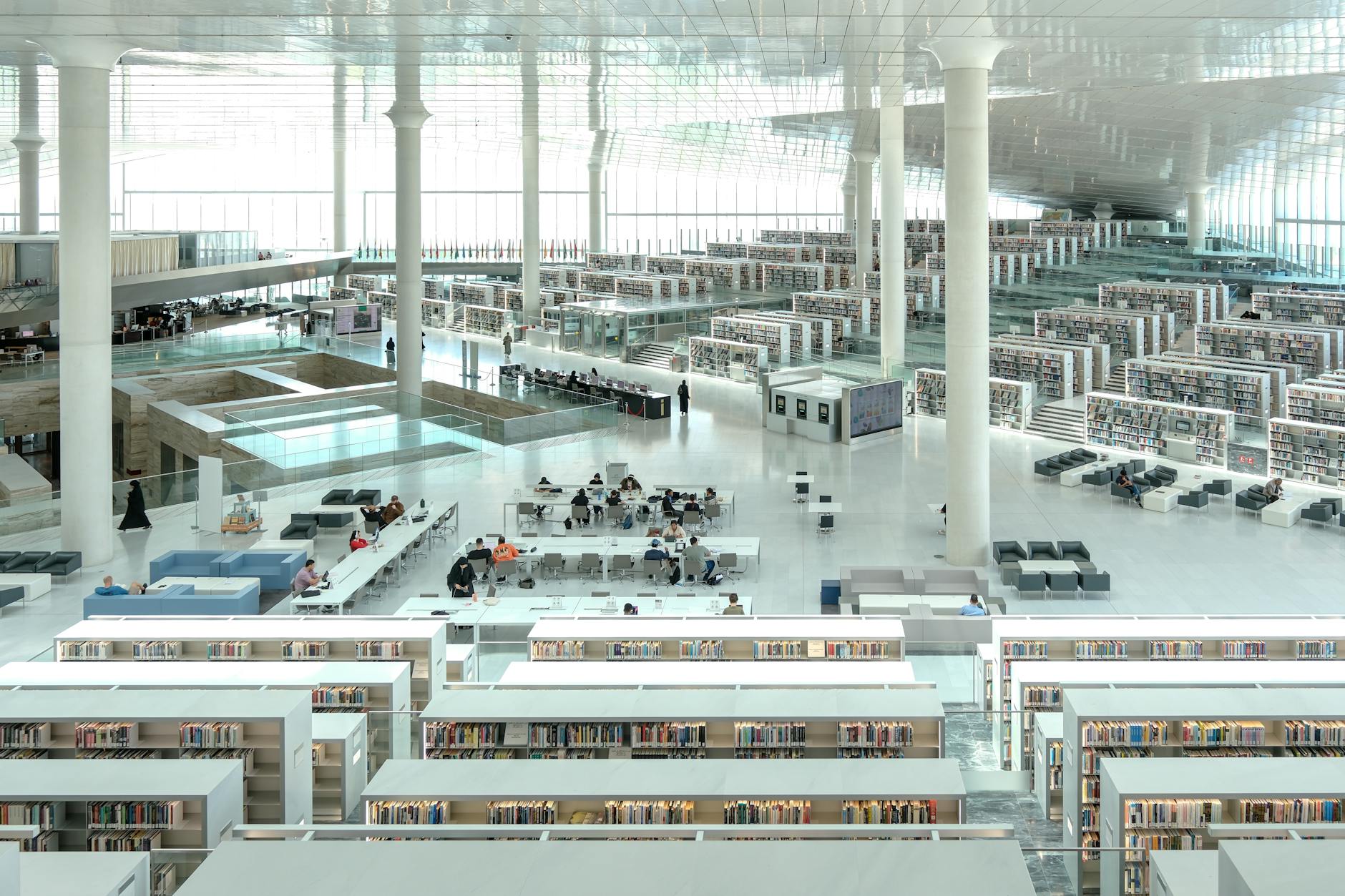 Modern library interior with tables and chairs arranged for collaborative work