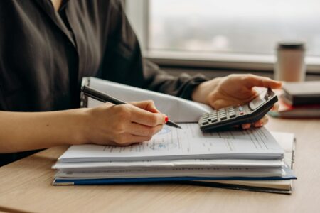 Financial calculator and retirement planning documents on desk