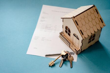 House keys on a mortgage document representing home buying decisions