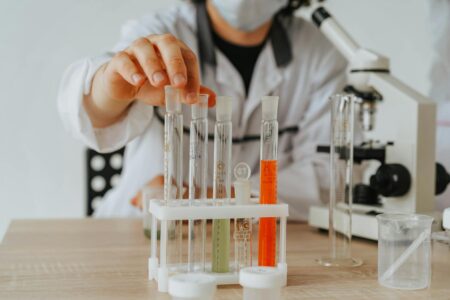 Scientists working in pharmaceutical research laboratory with equipment and samples