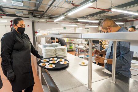 Professional commercial kitchen with stainless steel equipment and prep stations