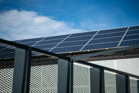 Solar panels installed in rows under bright sunlight generating renewable energy