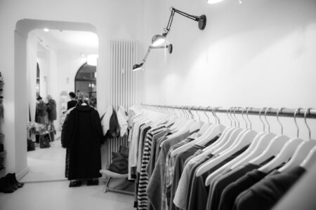 Vintage clothing hanging on rack showing various colorful garments and styles