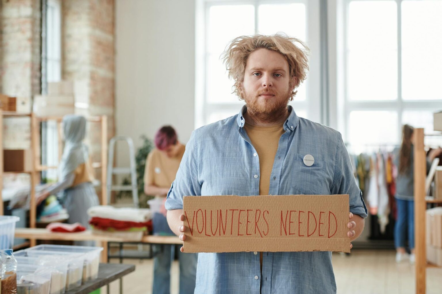Corporate employees participating in volunteer activities in modern office setting