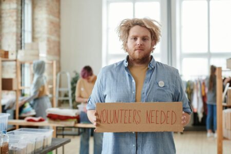 Corporate employees participating in volunteer activities in modern office setting
