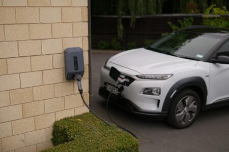 Electric vehicle connected to charging station at modern charging facility