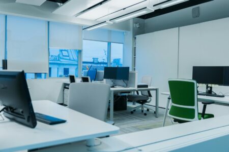 Modern coworking space with open layout, desks, and professional lighting