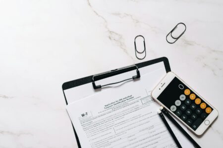 Financial documents and calculator showing tax planning calculations for retirement conversions