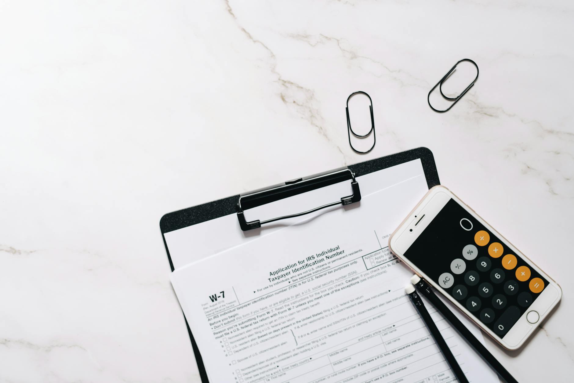 Financial documents and calculator showing tax planning calculations for retirement conversions