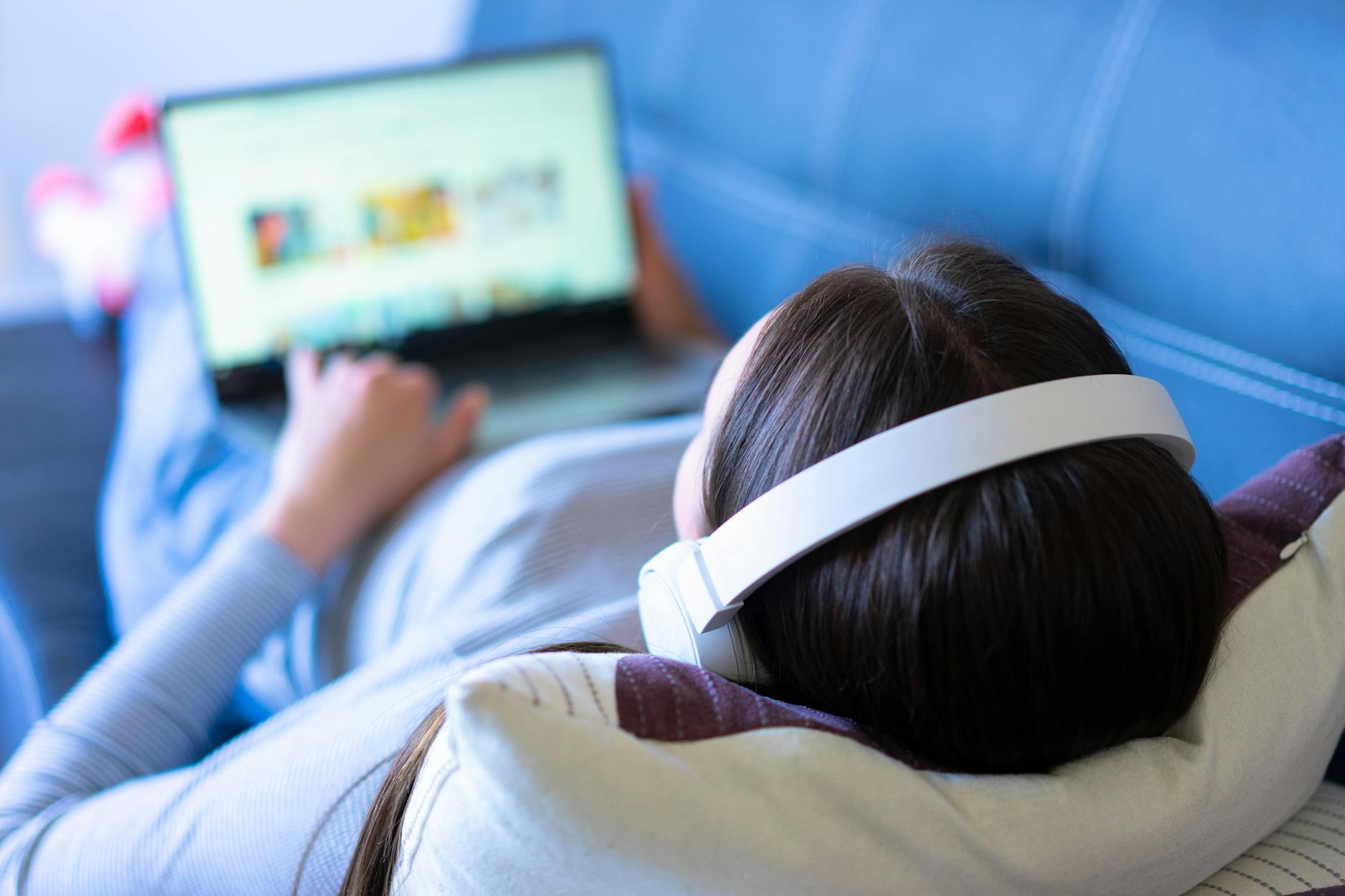 Person using laptop for video streaming or virtual event