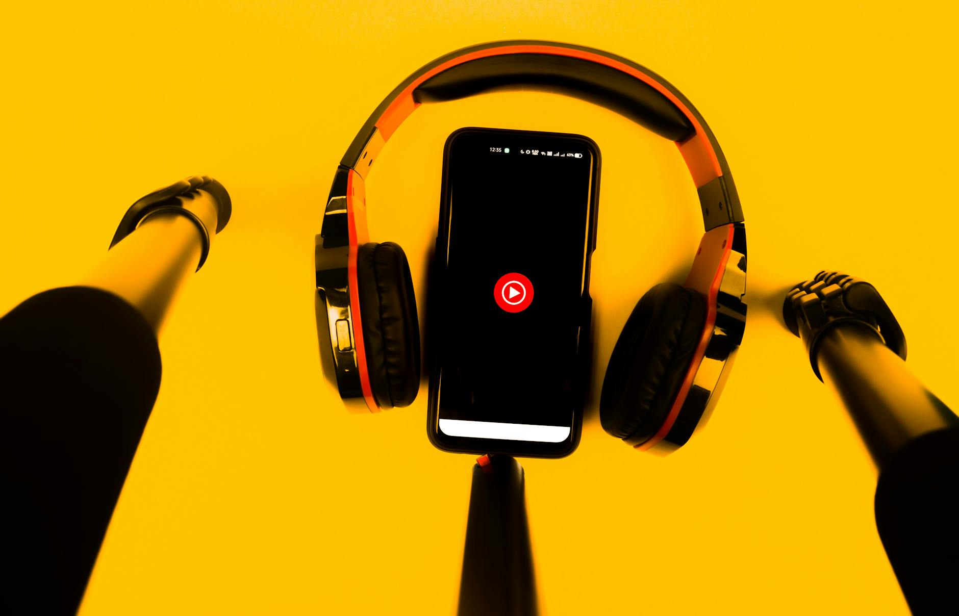 Person listening to audio content on smartphone with wireless headphones