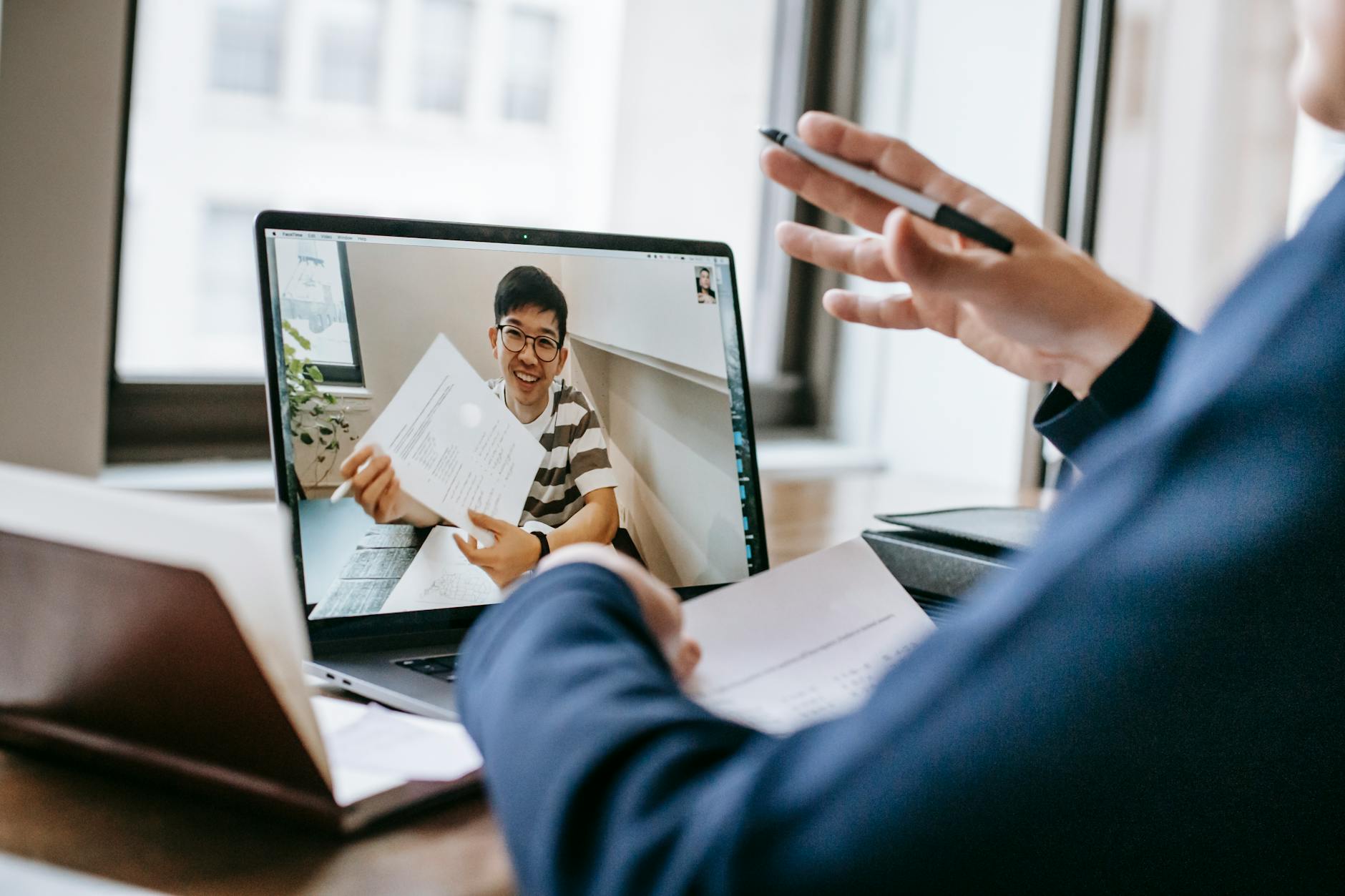 Healthcare professional conducting video consultation on computer screen in clinical setting
