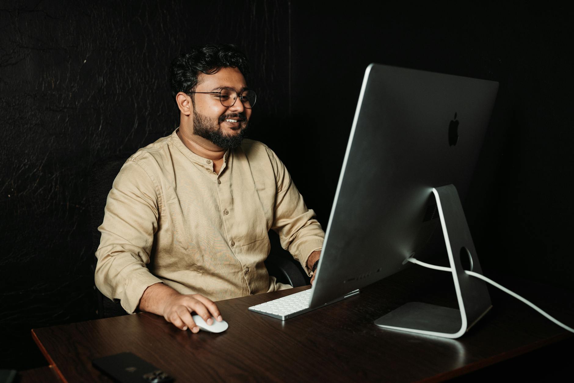 Professional employee at desk reviewing documents and considering reporting concerns through corporate channels