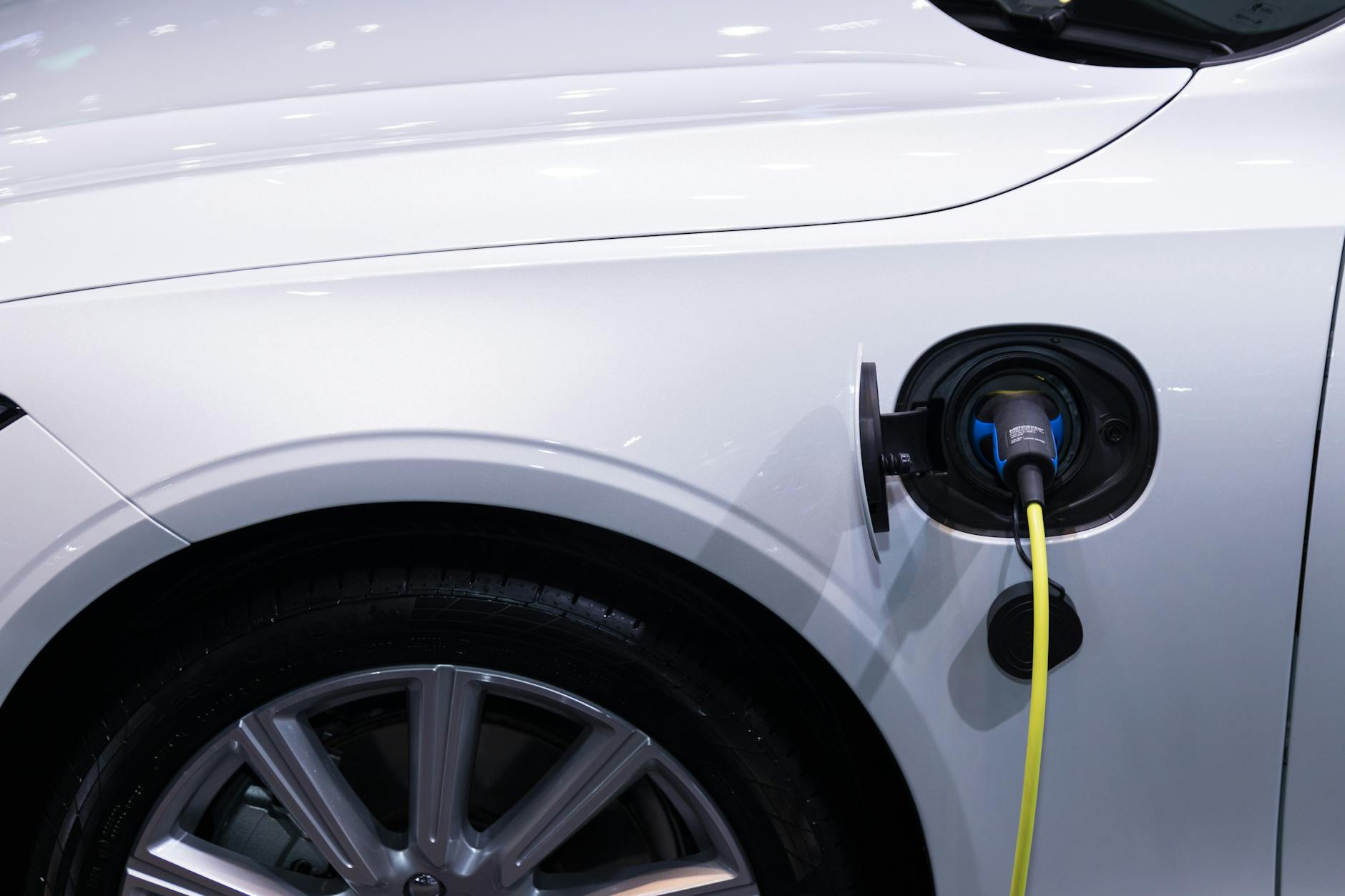 Electric vehicle connected to a charging station with charging cable