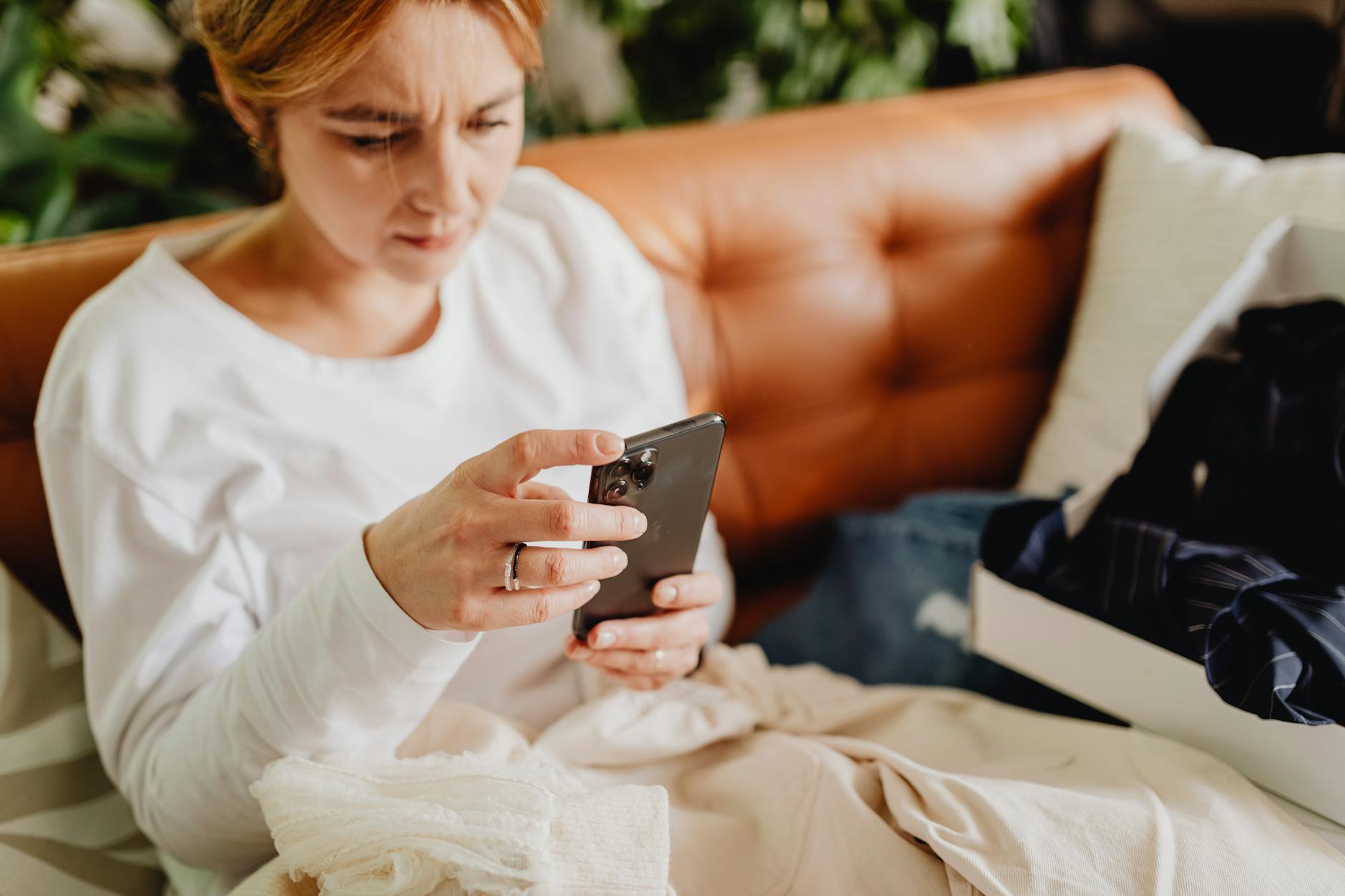 Professional woman using smartphone for business communications and online selling