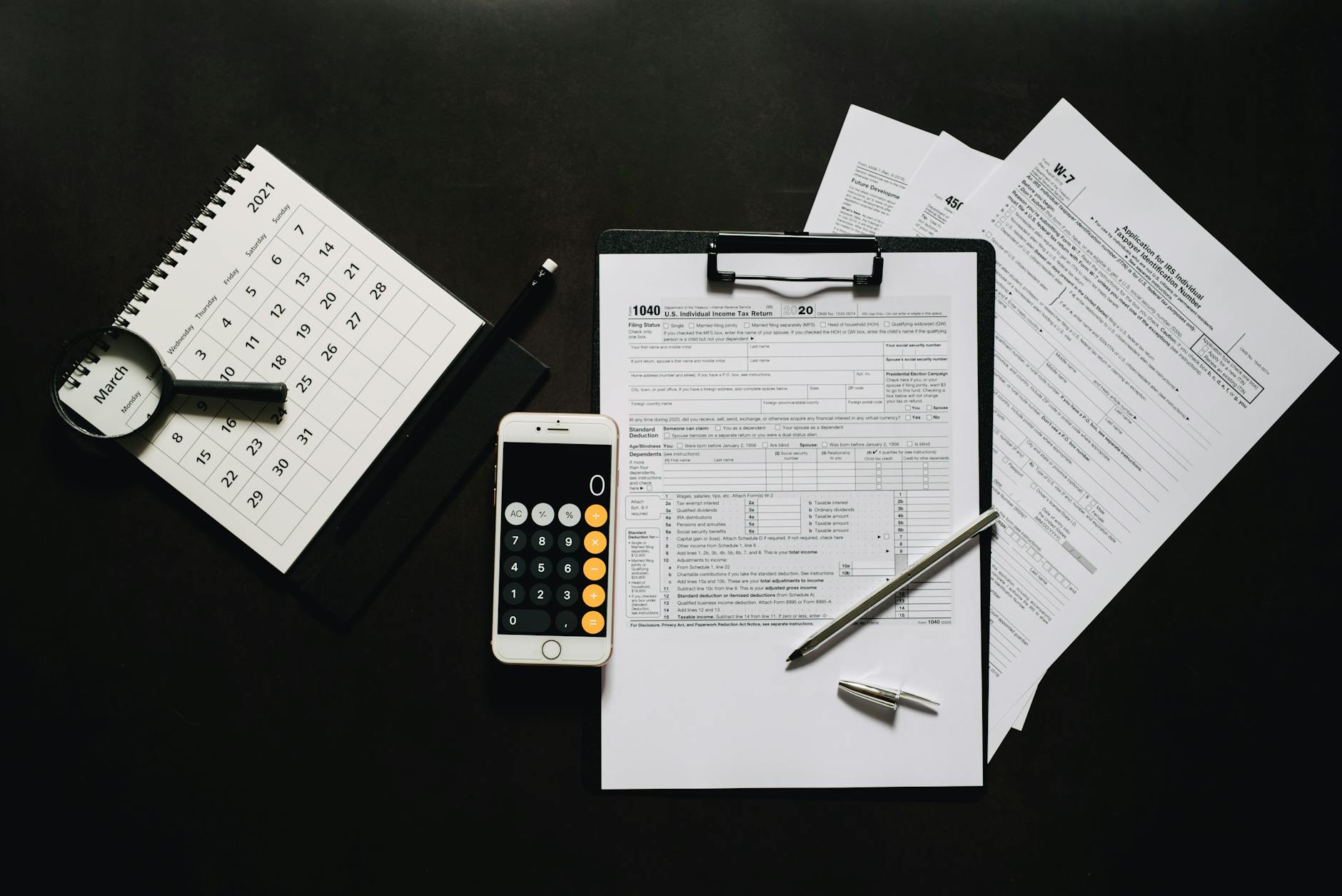 Financial calculator and documents showing tax planning calculations