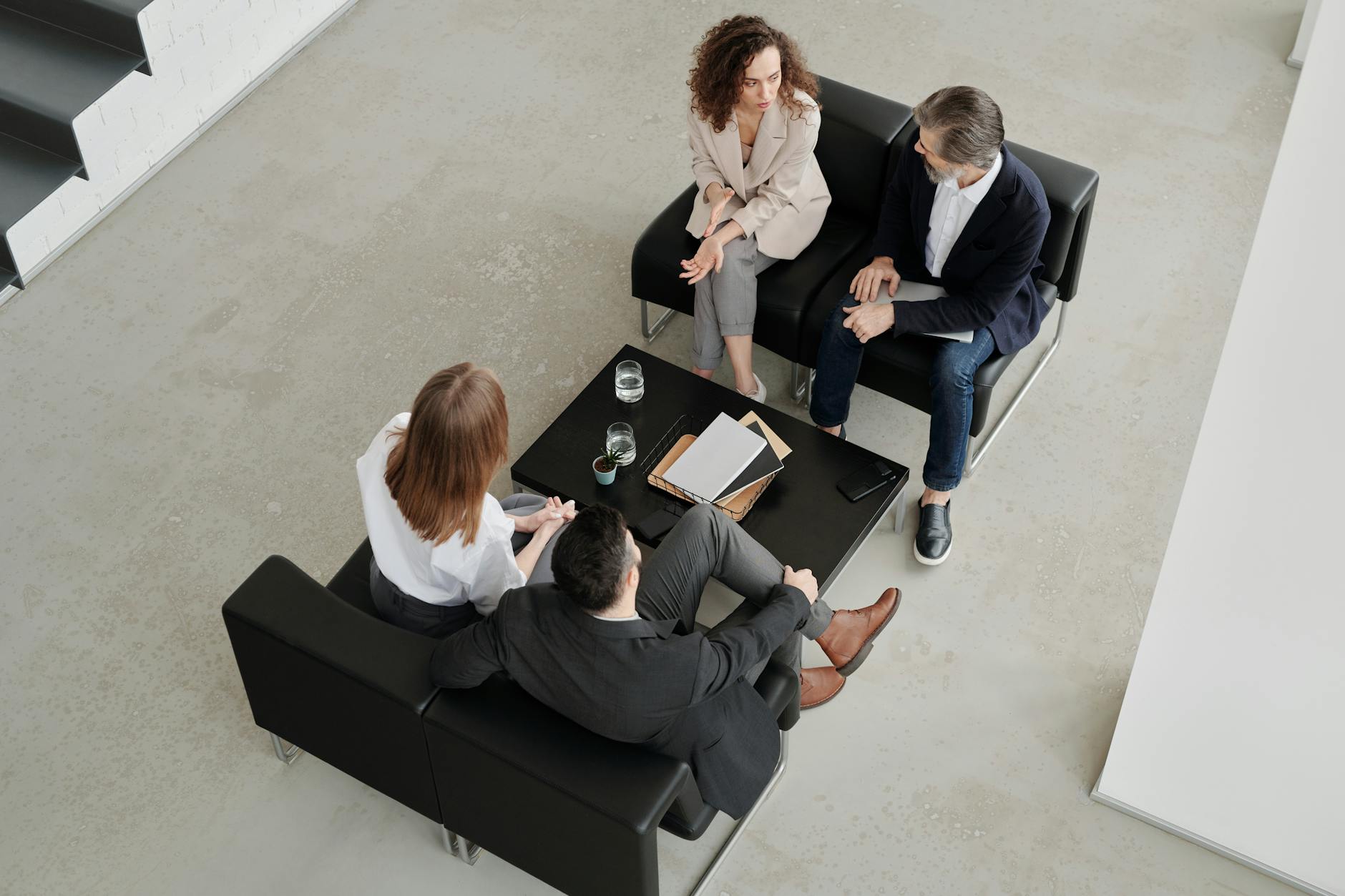 Business professionals discussing strategy and financial models in modern office setting