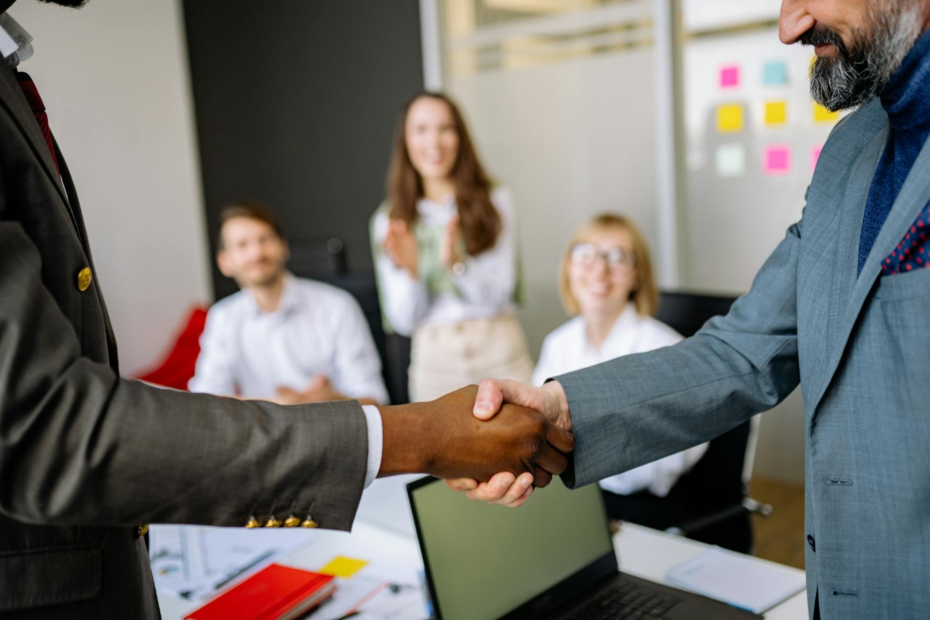 Professional handshake representing employee retention and workplace trust