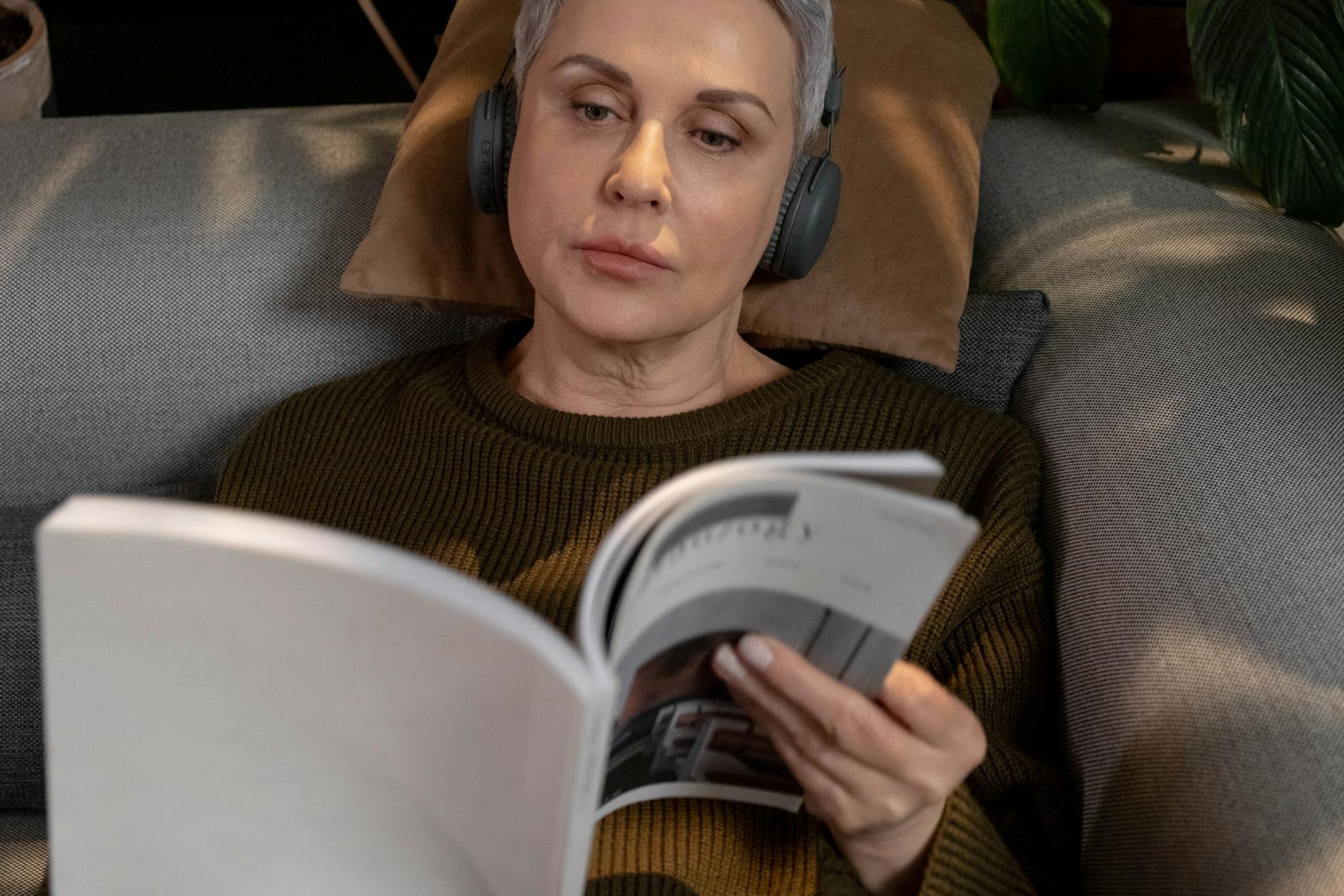 Person wearing headphones while listening to audio content