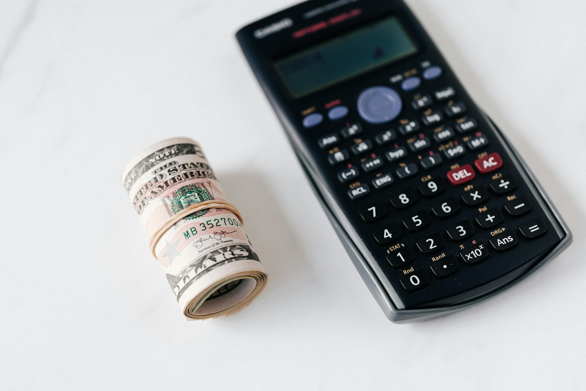 Calculator with money and financial documents representing investment returns and yield calculations