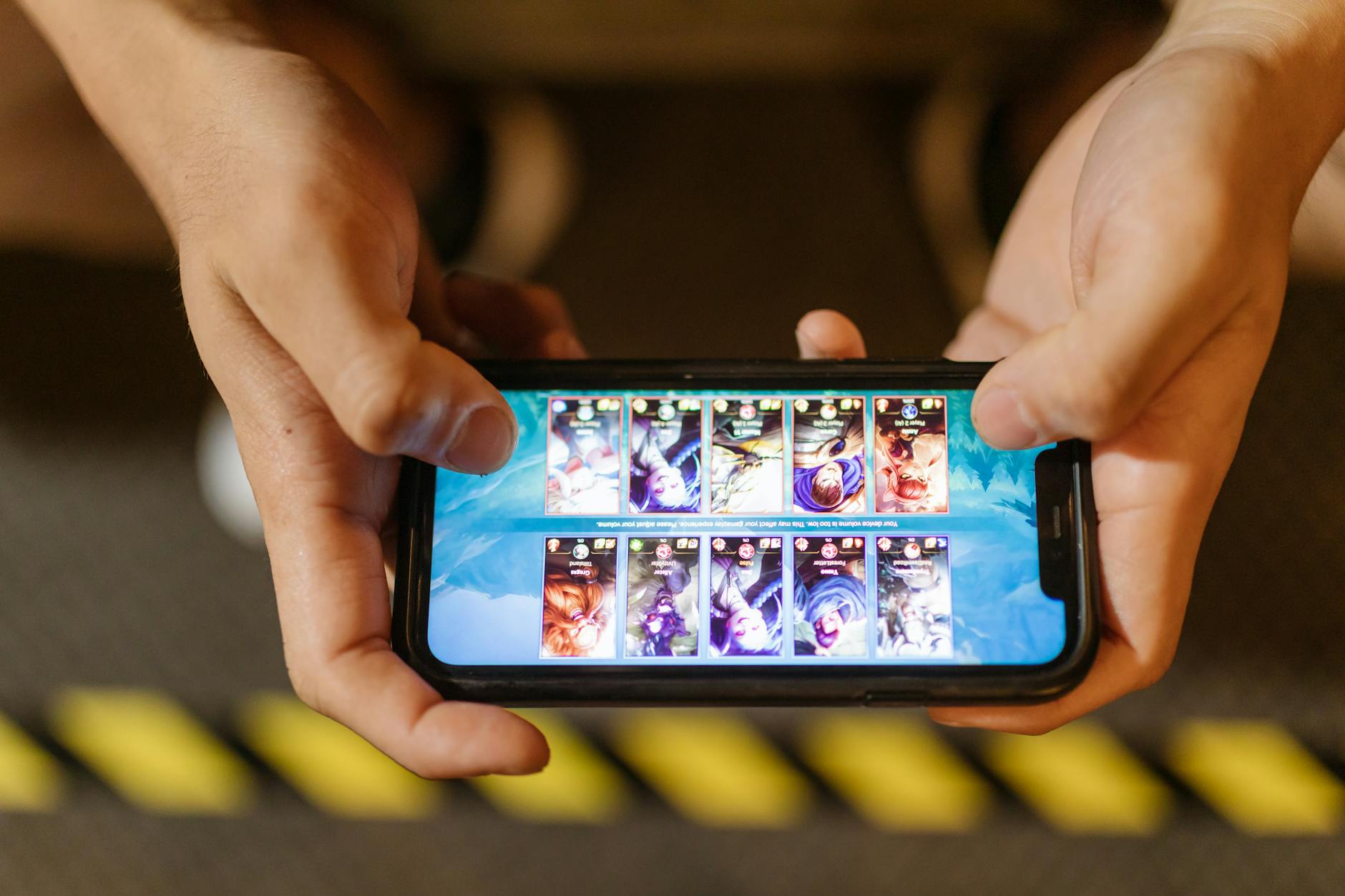 Person playing mobile games on smartphone and tablet devices