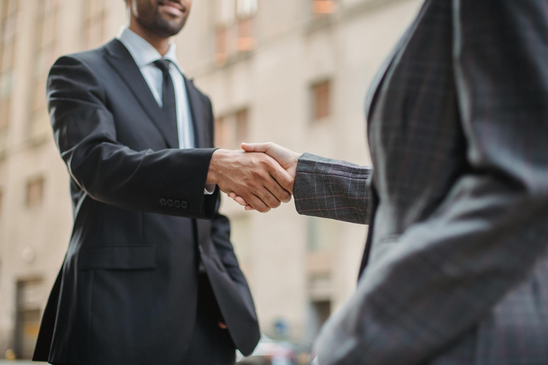 Professional handshake between colleagues, symbolizing successful employee retention and workplace relationships