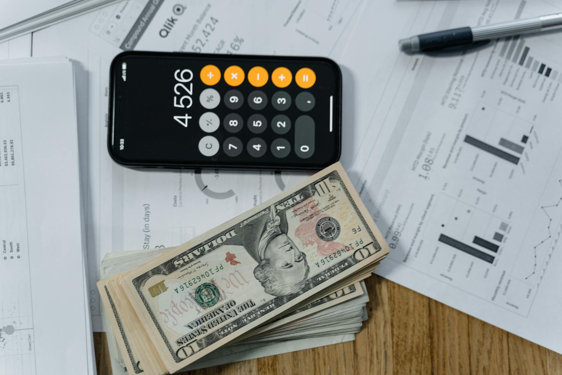 Financial documents and calculator on desk representing business revenue