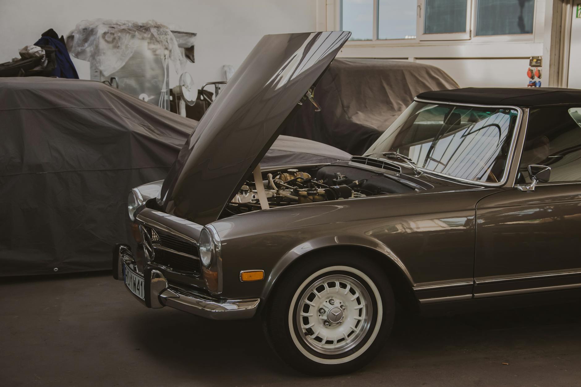 Classic car in restoration shop being prepared for electric conversion work