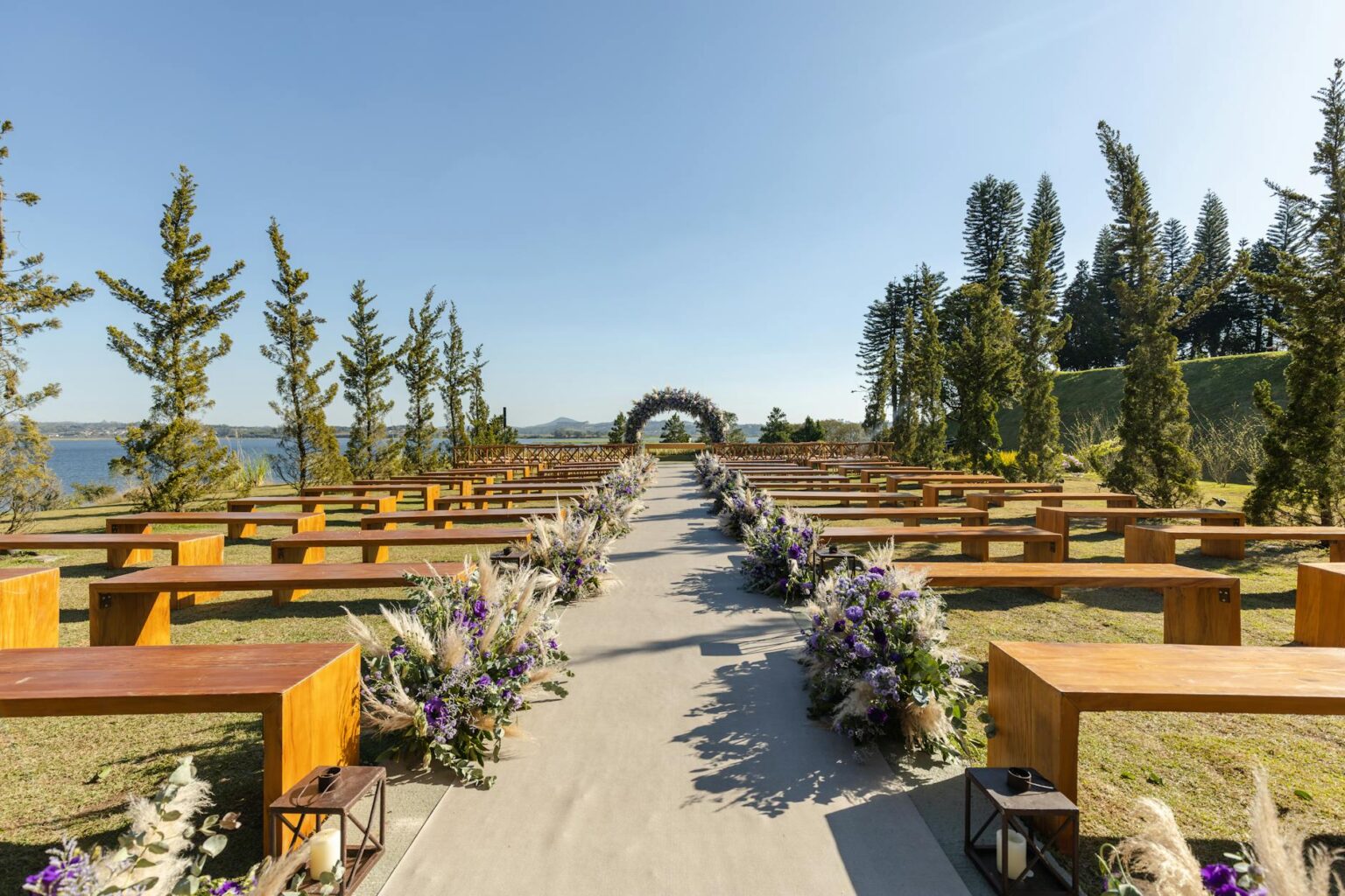 Elegant outdoor wedding venue setup with tables and chairs arranged for intimate ceremony