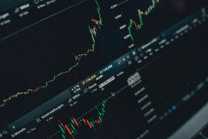 Stock market charts showing price movements and volatility on a trading screen