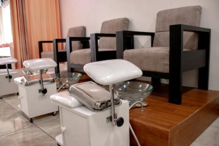 Professional nail salon interior with manicure stations and modern equipment