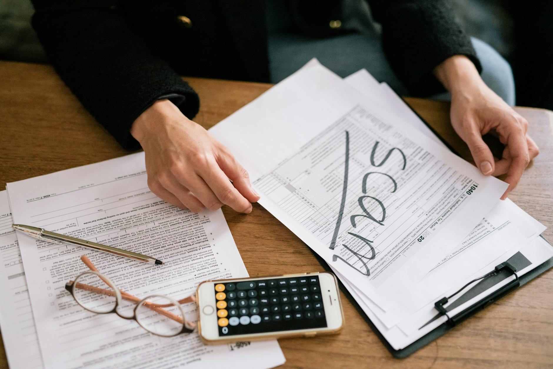 Tax documents and financial paperwork spread across a desk