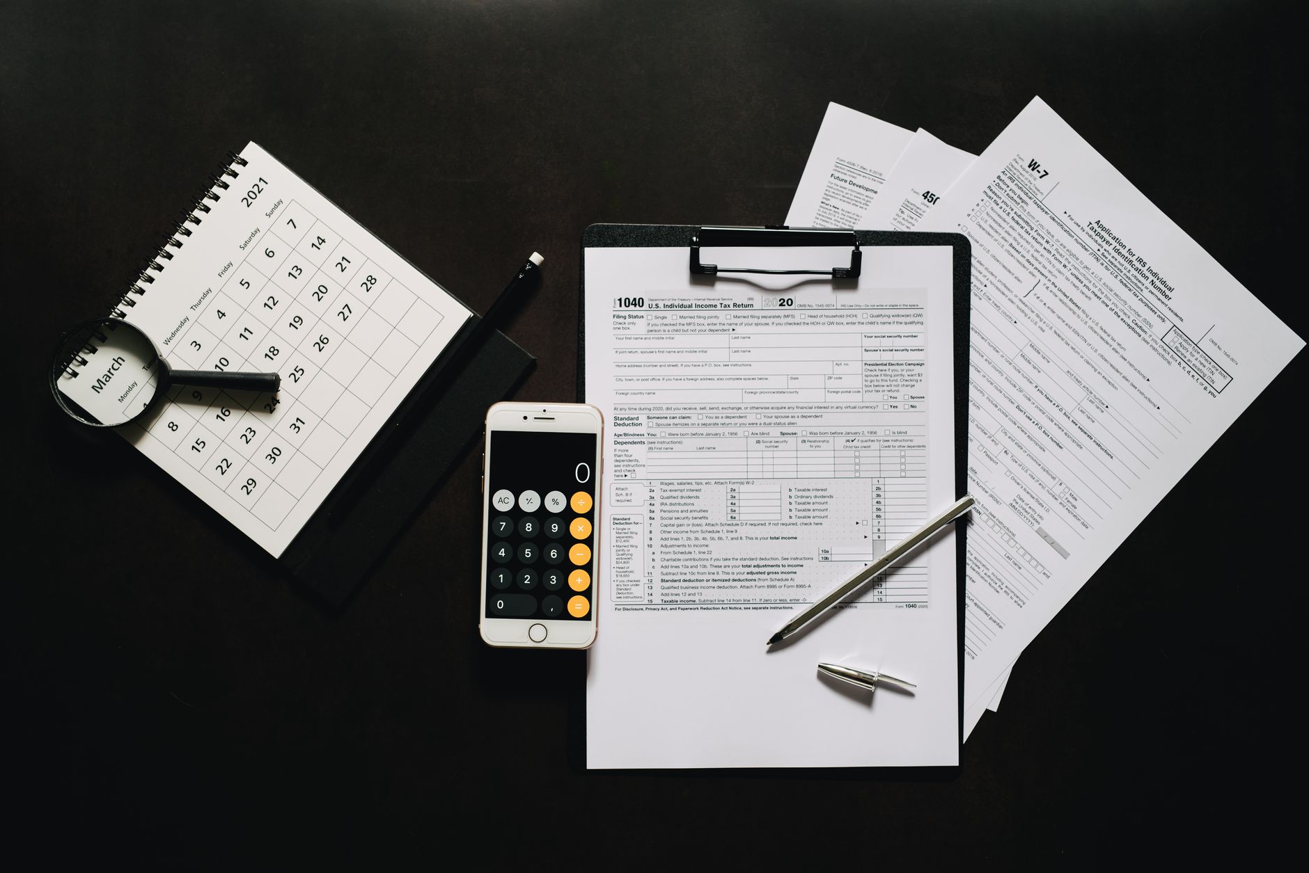 Calculator and financial documents used for tax planning calculations