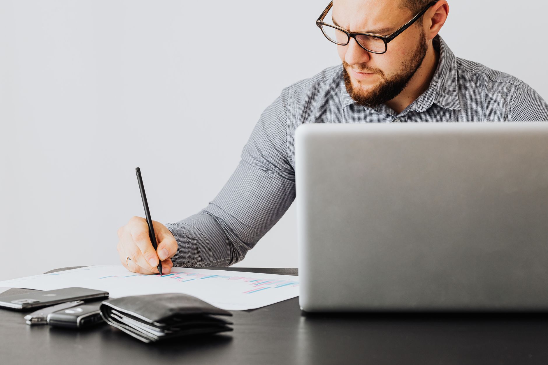 Financial documents and charts spread across an advisor's desk