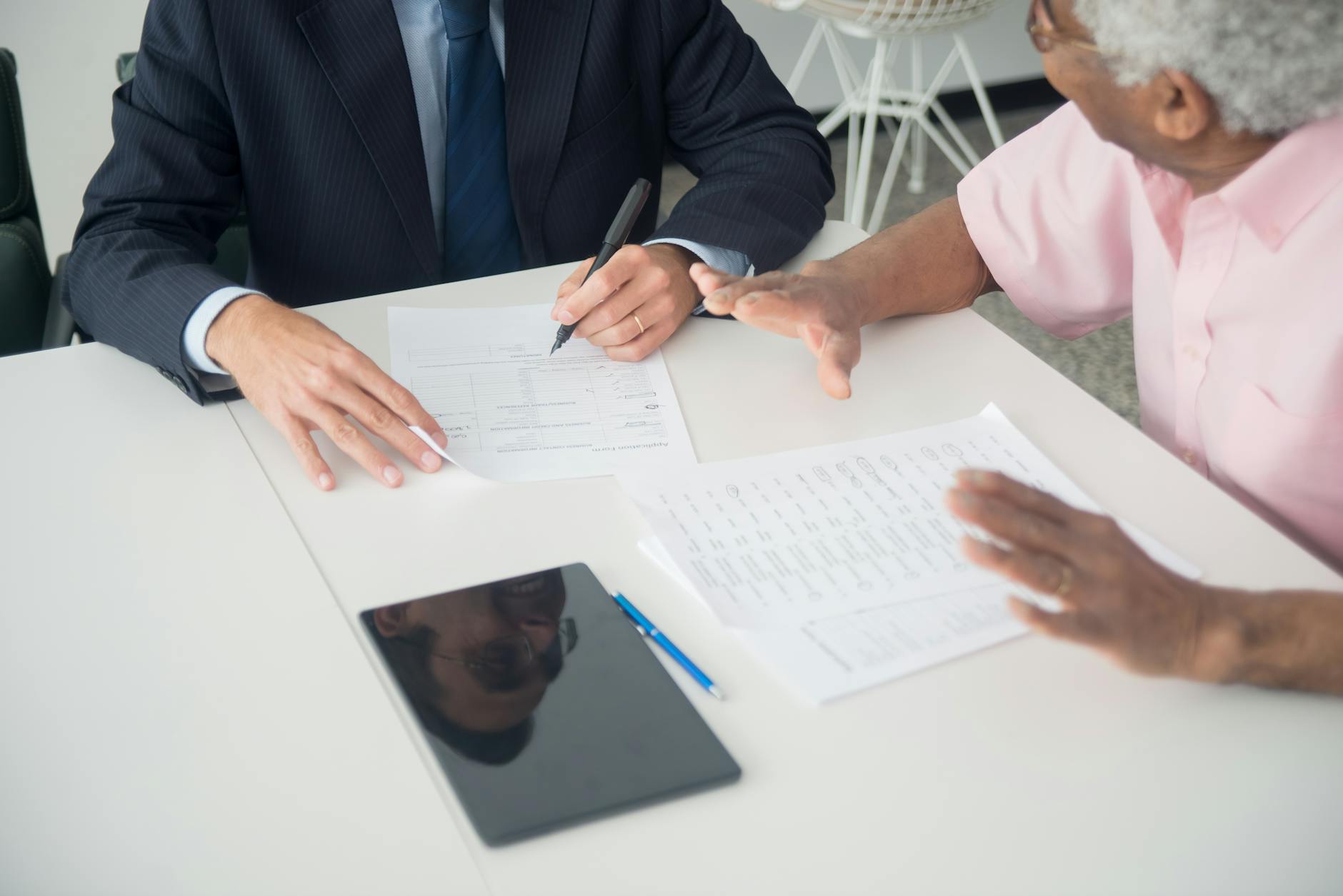 Financial advisor reviewing portfolio charts with a client at a desk