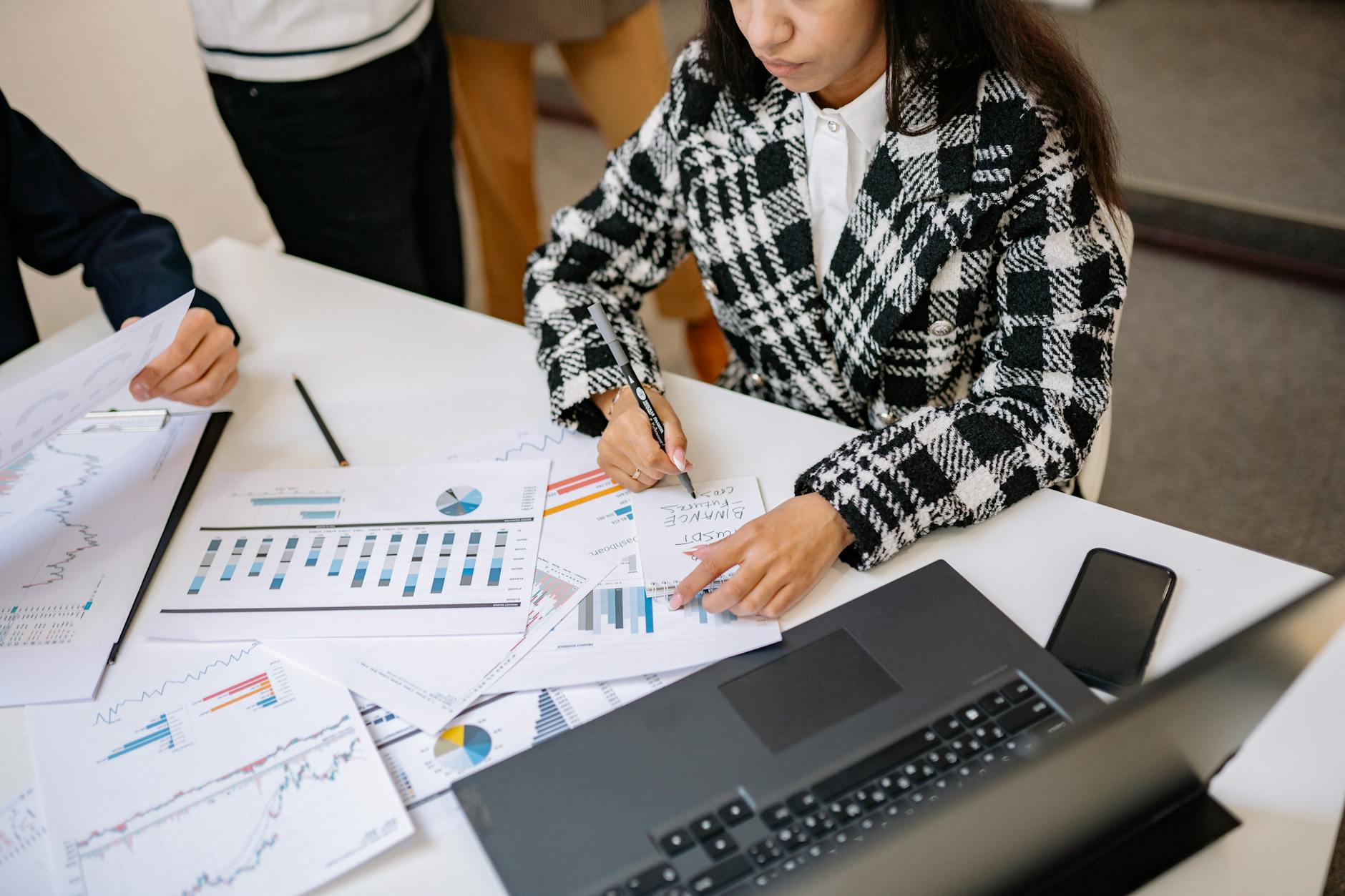 Business professionals reviewing financial documents at a conference table