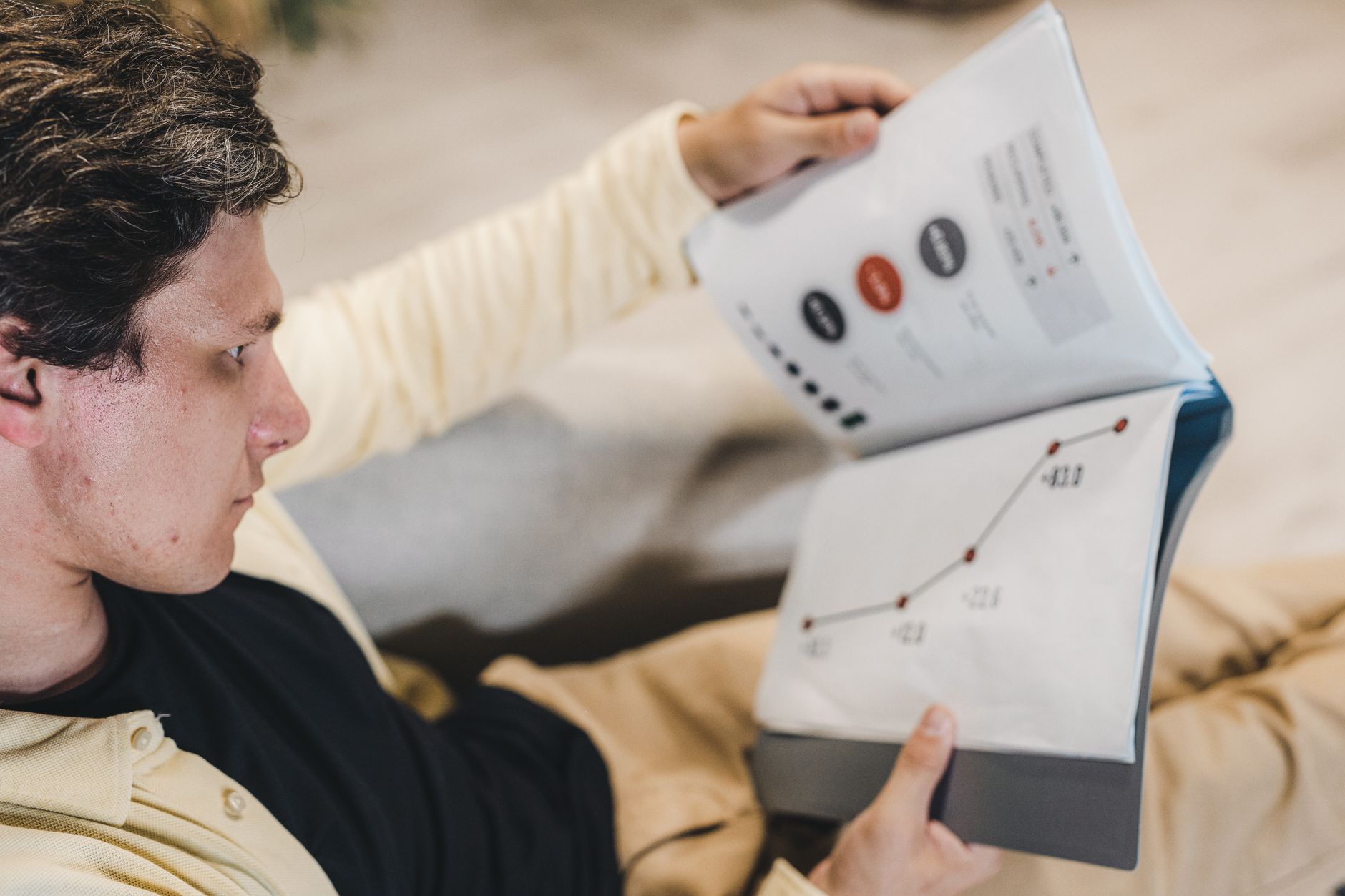 Investor reviewing financial documents and SEC filings at a desk