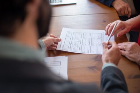 Close-up of an insurance contract document on a desk, representing reinsurance agreements