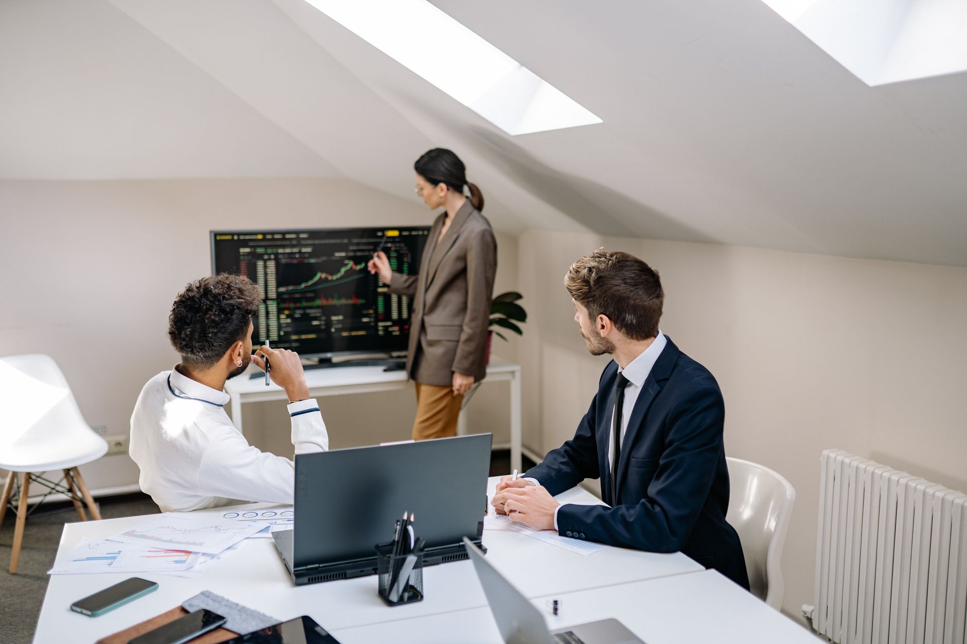Investment professionals reviewing structured finance documents at a conference table