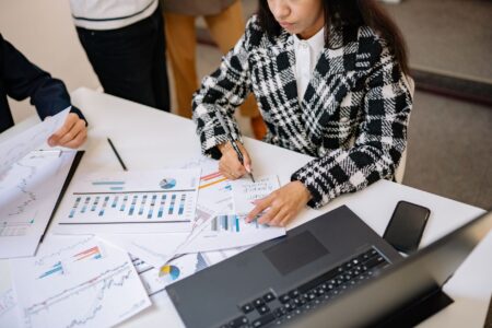 Two professionals reviewing investment fund documents at a conference table