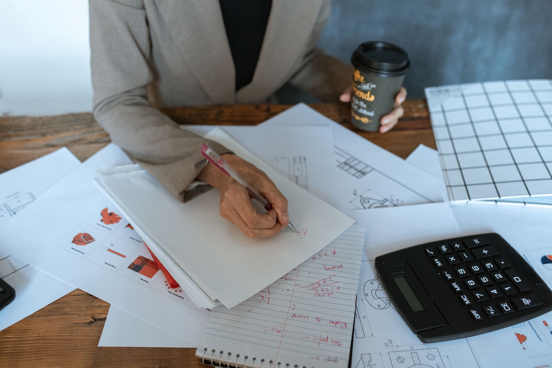 Financial documents and charts spread across a desk representing investment analysis