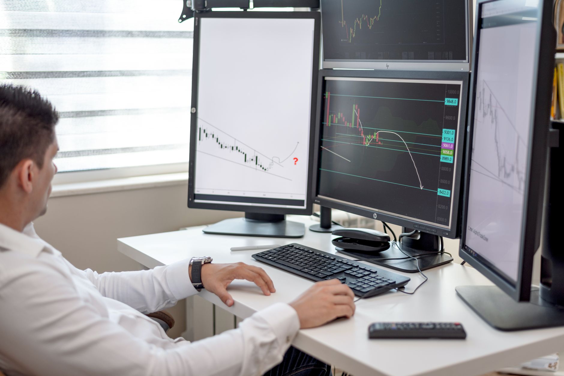 Multiple financial trading screens displaying commodity futures and market data