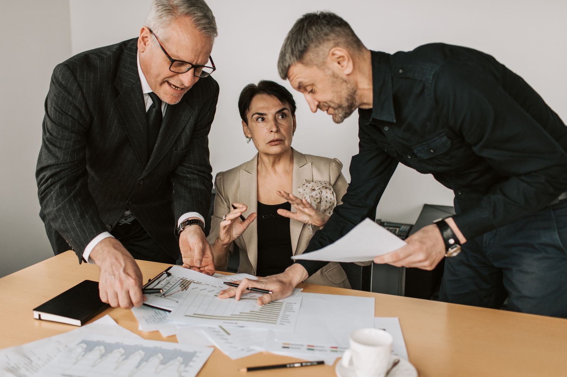 Two professionals reviewing investment portfolio documents in a modern office setting