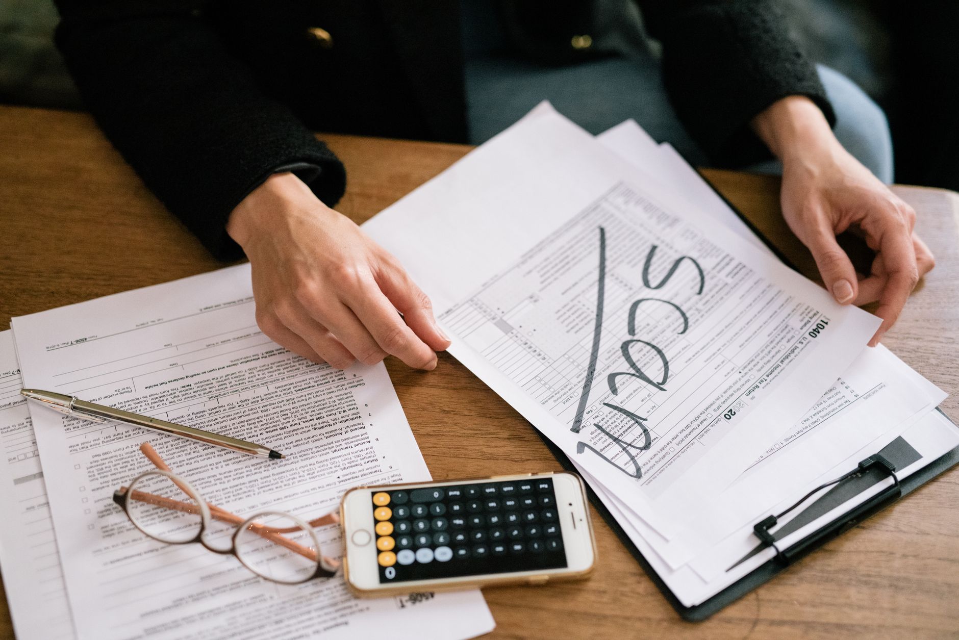 Tax documents and financial paperwork spread across a desk